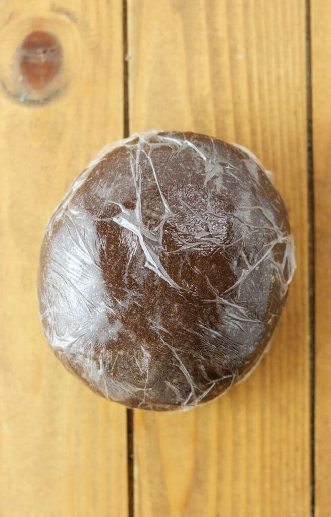 Cookie dough ball, wrapped with plastic foil, ready to be chilled in the fridge before baking the cookies.